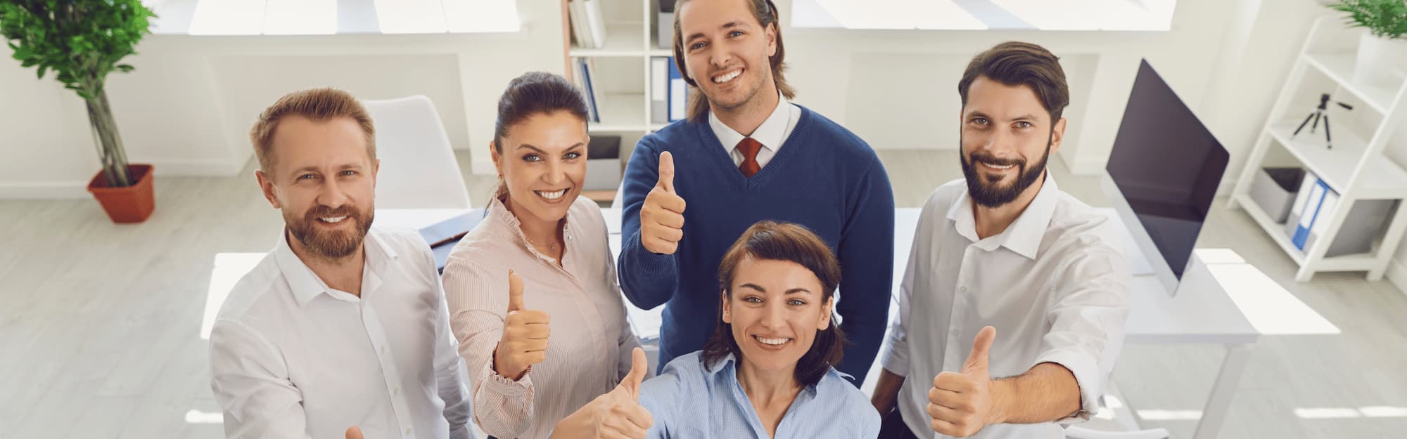 group of coworkers giving a thumbs up
